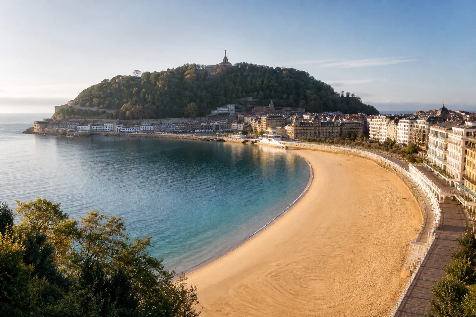 La Concha beach in San Sebastián forming a pale crescent under morning light
